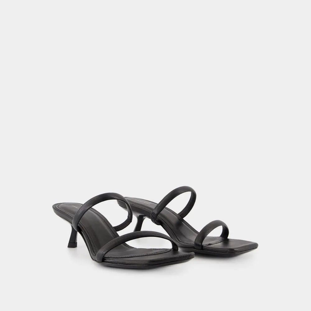 Sleek Black Calfskin Mules With Curved Heel